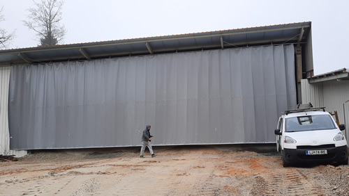 big outdoor tarp curtain on track and trolley